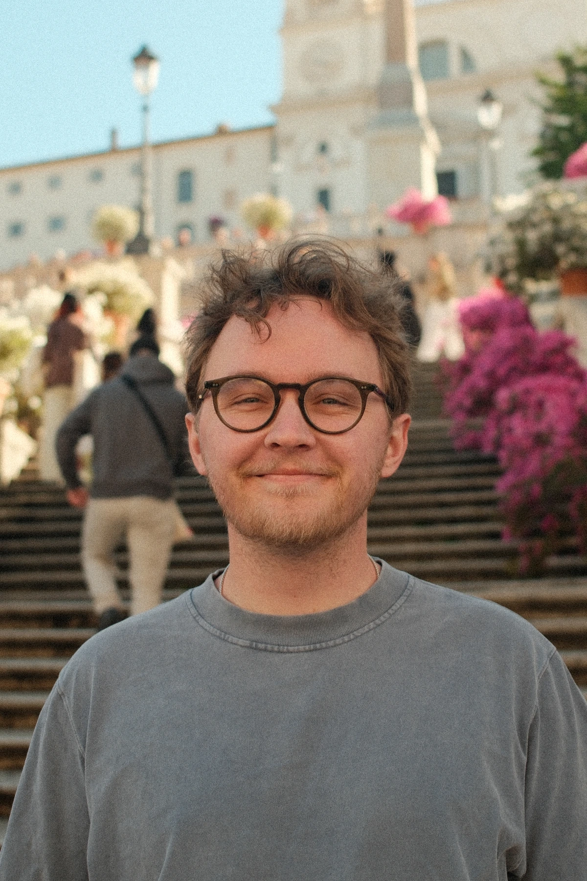 Lukas Viskanta in Rome, smiling in round glasses