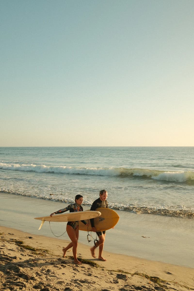 Surfers walking at golden hour